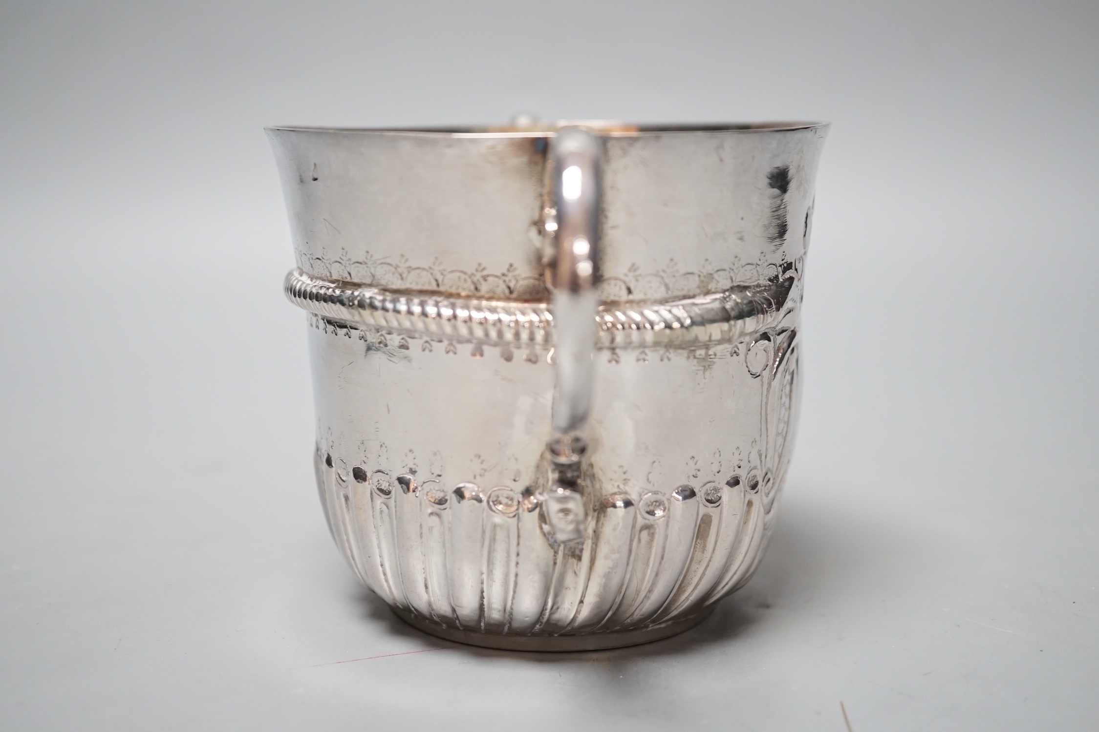 A George I embossed silver porringer, by Thomas Fort, London, 1714, height 91mm, 198 grams, (repairs).